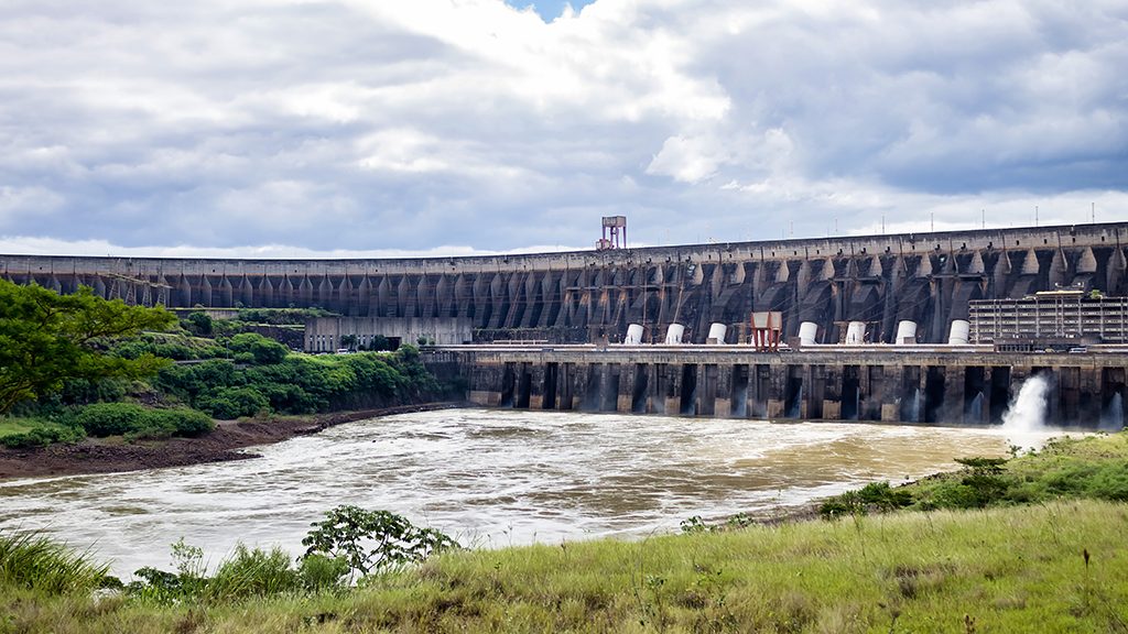 Photo of modern giant dam, located on Parana river. Itaipu Binacional hydroelectric power station in Foz do Iguazu Brazil on border with Paraguay. Hydro electrification concept. Copy ad text space